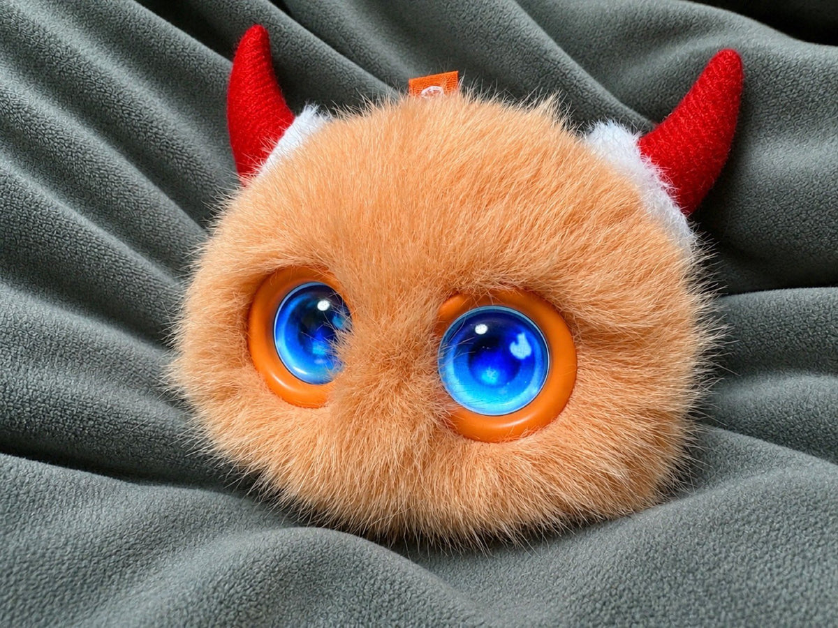 Orange Fuzozo wearing red horns