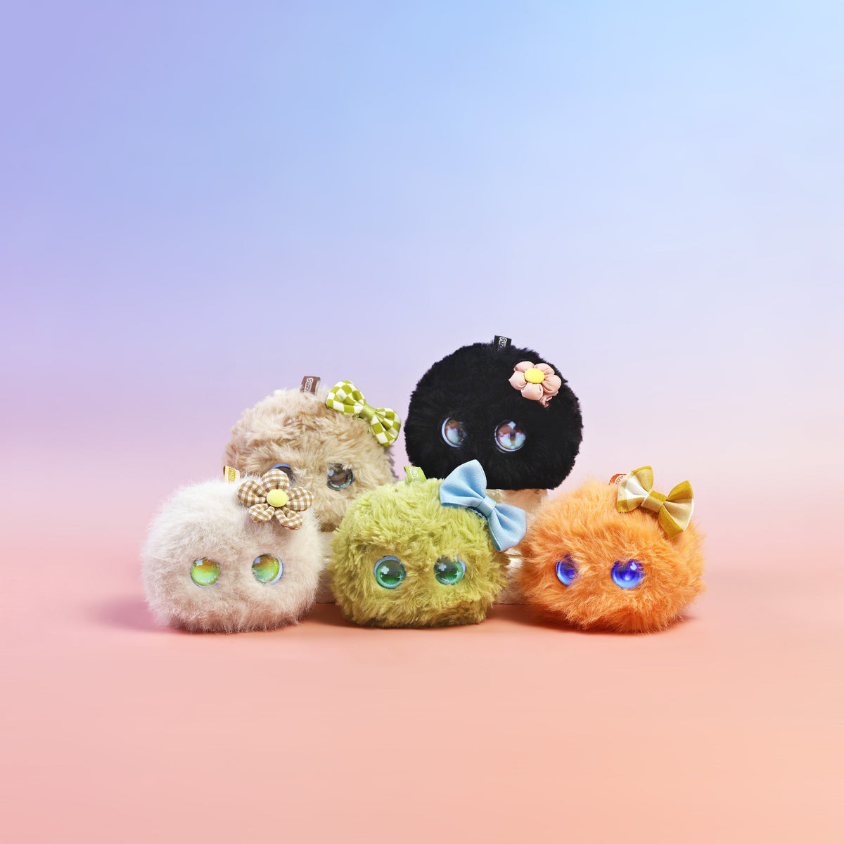 Five Fuzozos wearing mini hair clips in different colors