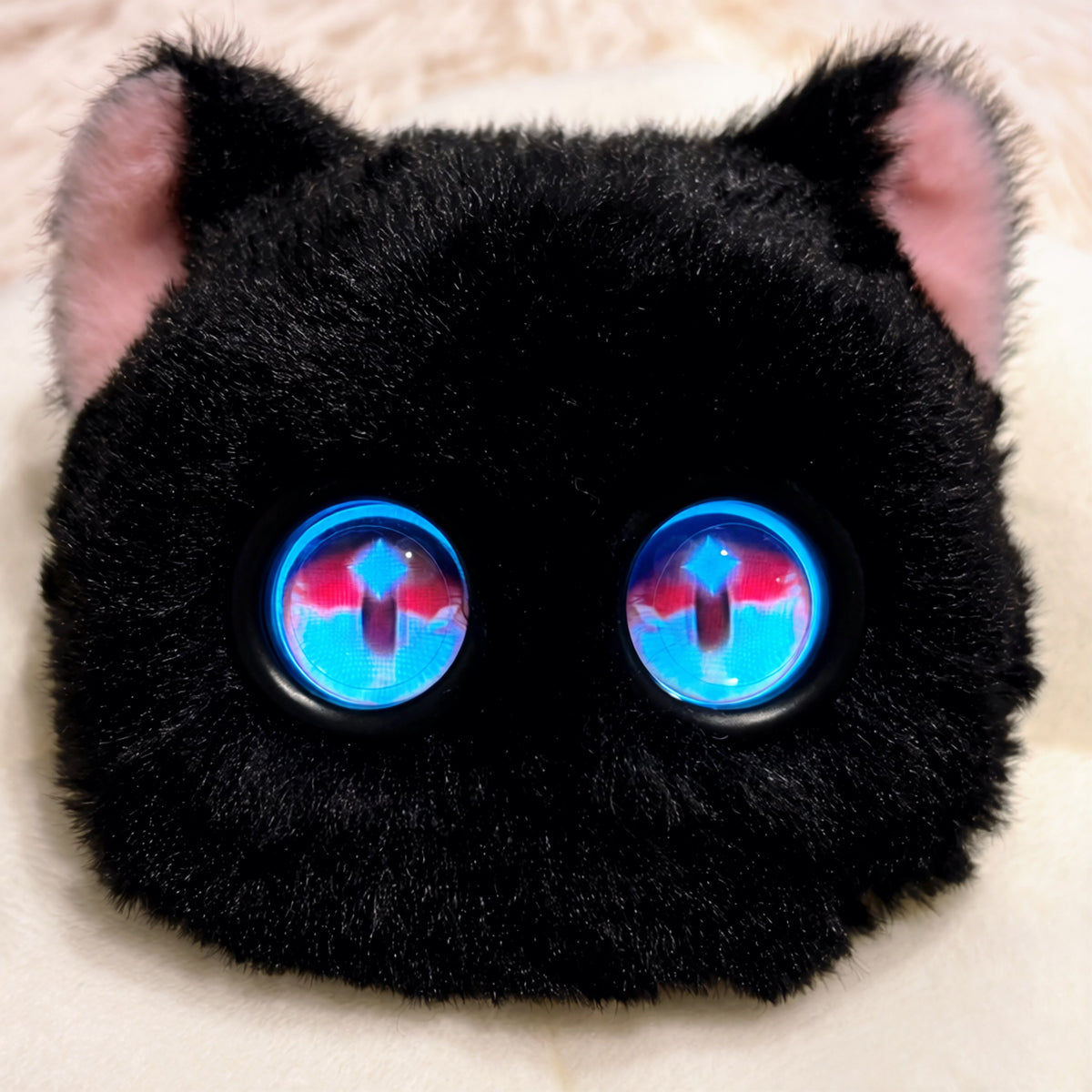 Black Fuzozo with pink cat ears and sparkling eyes