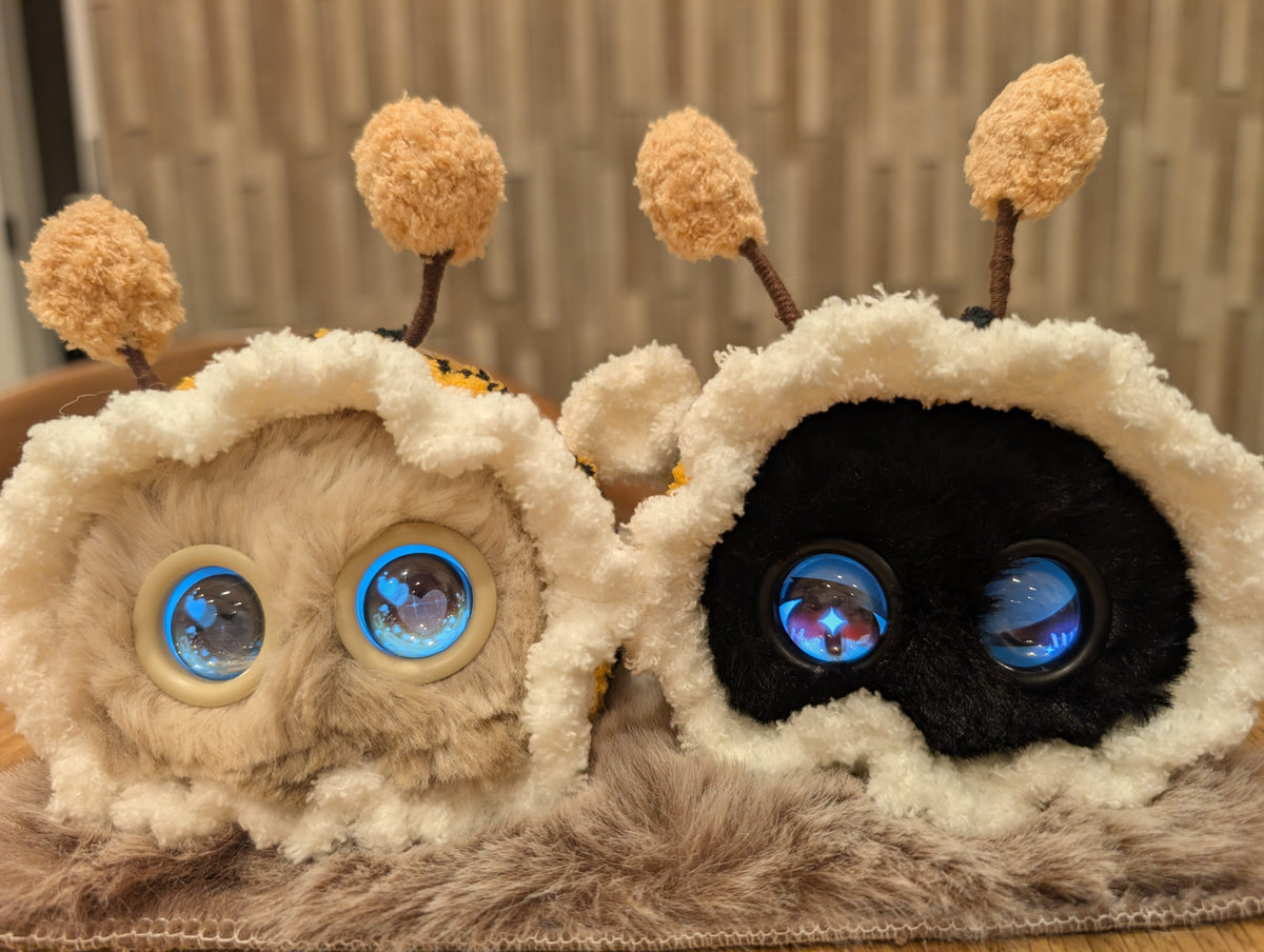 Beige and black Fuzozos in bee outfits
